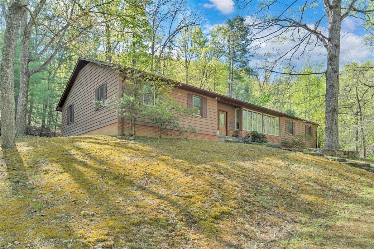 3878 Harborwood Road Salem, VA 24153 - Photo 45 of 60 a backyard of a house with large trees and table