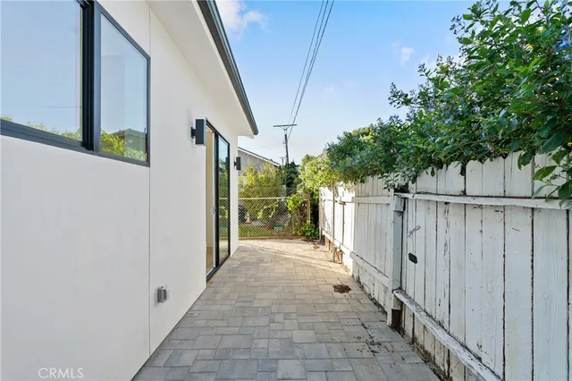a view of a pathway of a building with wooden fence