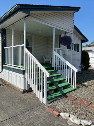 a view of a house with deck and a yard