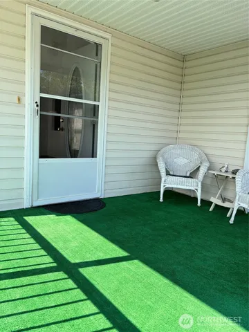 a backyard of a house with table and chairs