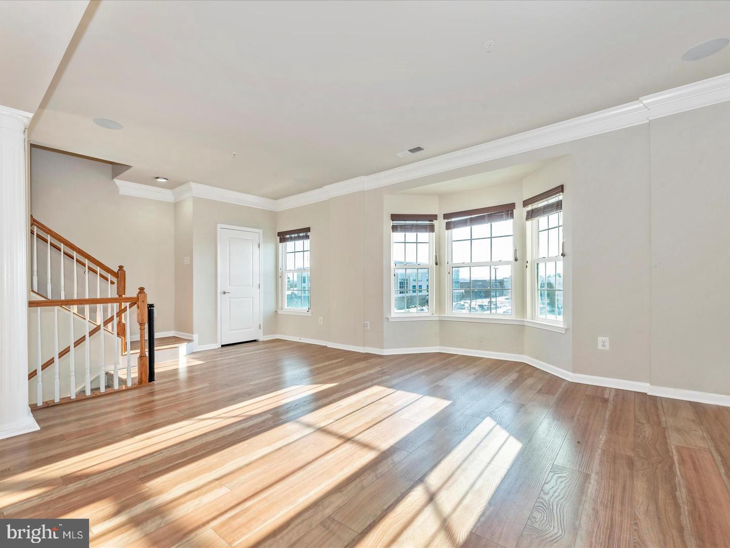 208 B Mill Pond Road Frederick, MD 21701 - Photo 4 of 45 a view of an empty room with wooden floor and a window