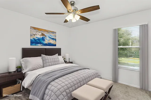 a bedroom with a bed and a painting on the wall