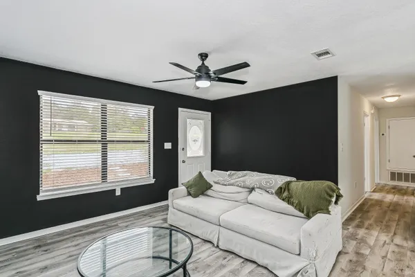 a living room with furniture and a large window