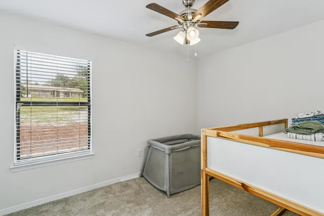 a view of room with window and ceiling fan