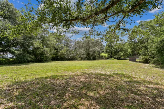 a view of a house with a yard and sitting area