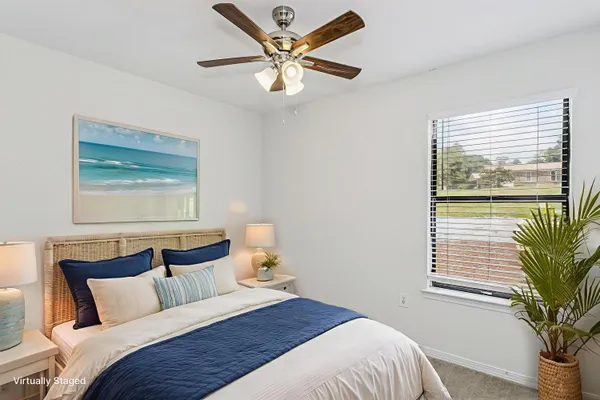 a bedroom with a large bed and a window