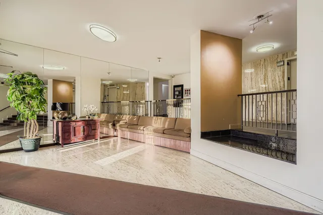 a kitchen with stainless steel appliances kitchen island granite countertop a refrigerator and a counter top space