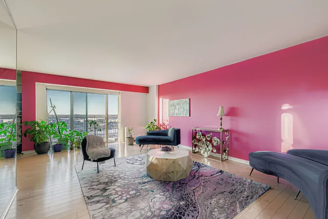 a living room with furniture potted plant and a window