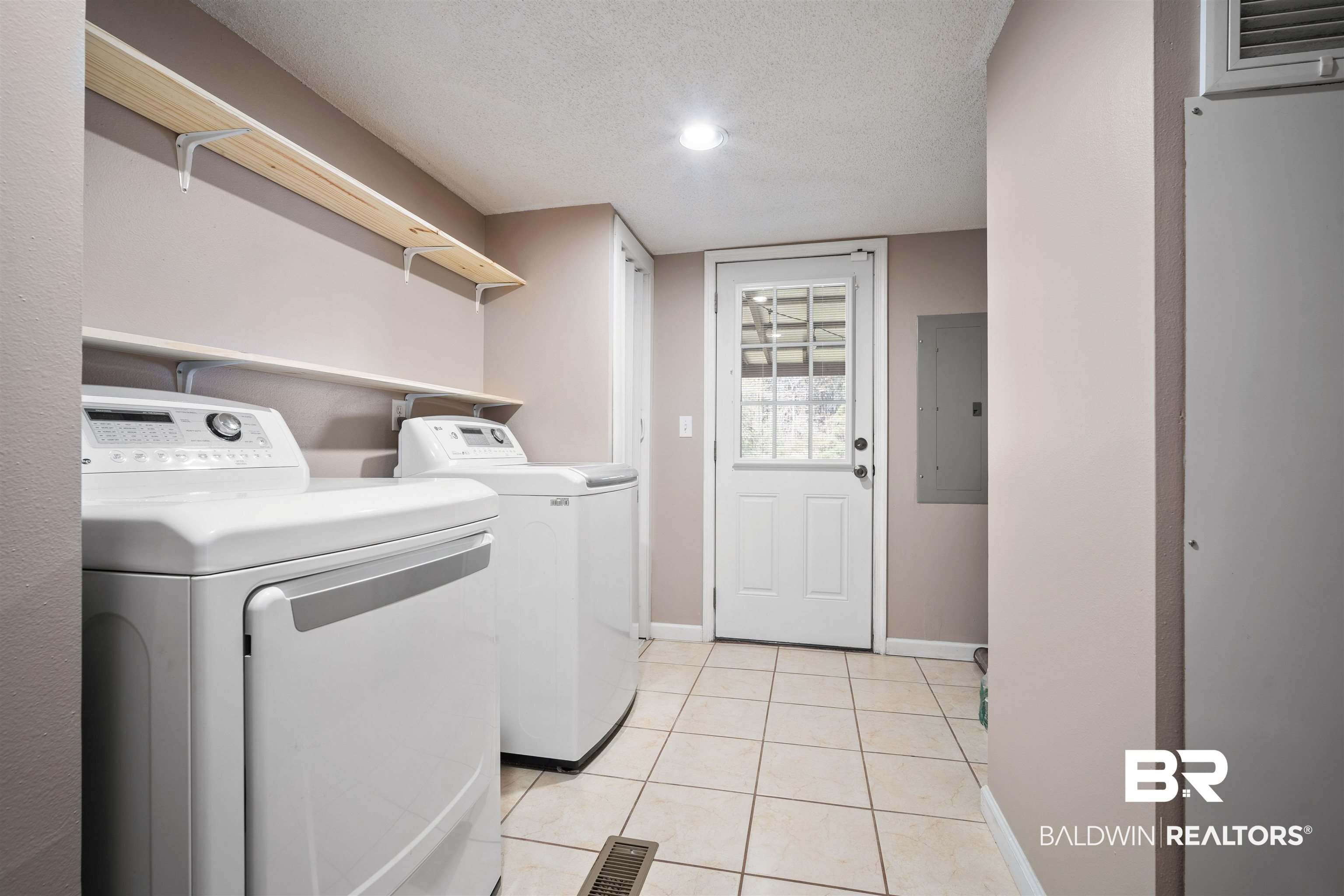 9011 Wilmer Georgetown Road Wilmer, AL 36587 - Photo 26 of 34 Laundry room with light tile patterned floors, a textured ceiling, washer and dryer, laundry area, and electric panel
