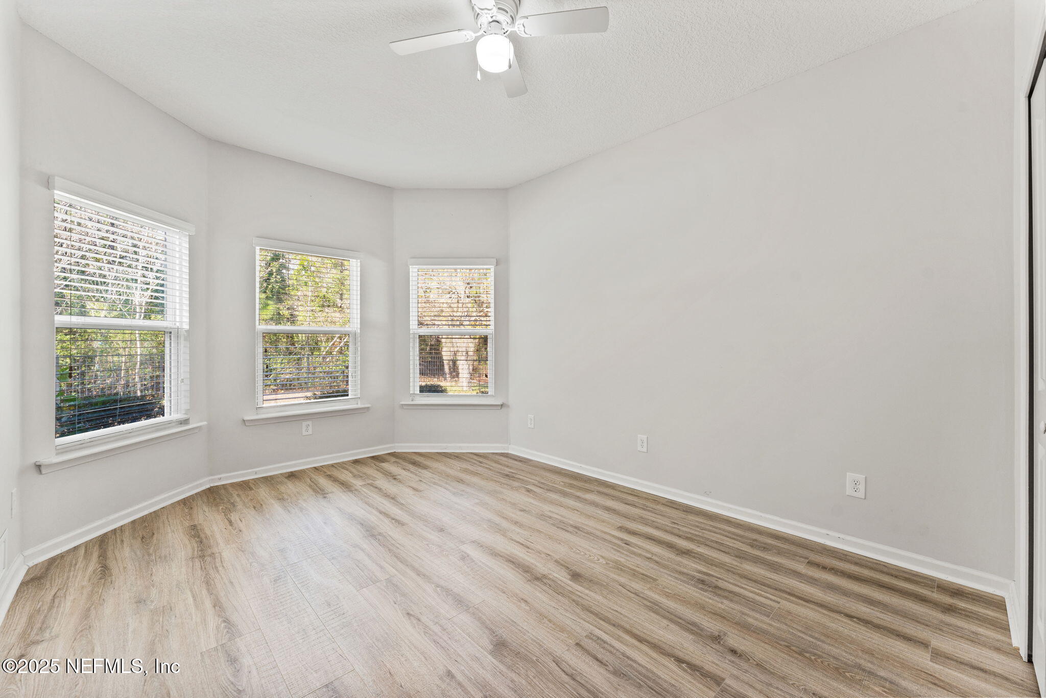 83029 Dowitcher Place Yulee, FL 32097 - Photo 21 of 40 wooden floor in an empty room with a window