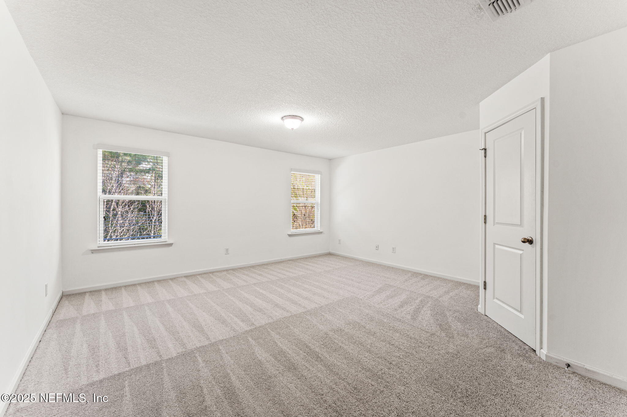 83029 Dowitcher Place Yulee, FL 32097 - Photo 24 of 40 an empty room with windows