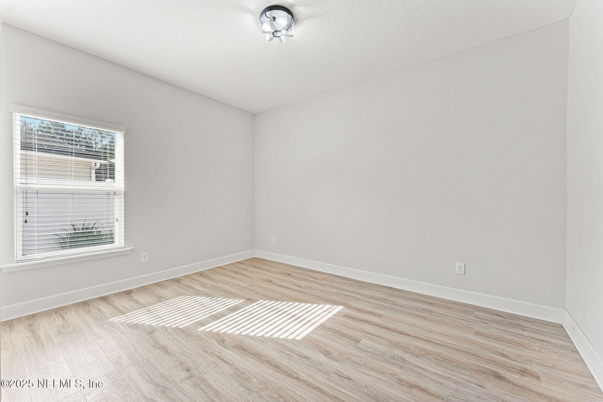 83029 Dowitcher Place Yulee, FL 32097 - Photo 26 of 40 a view of an empty room with wooden floor and a window