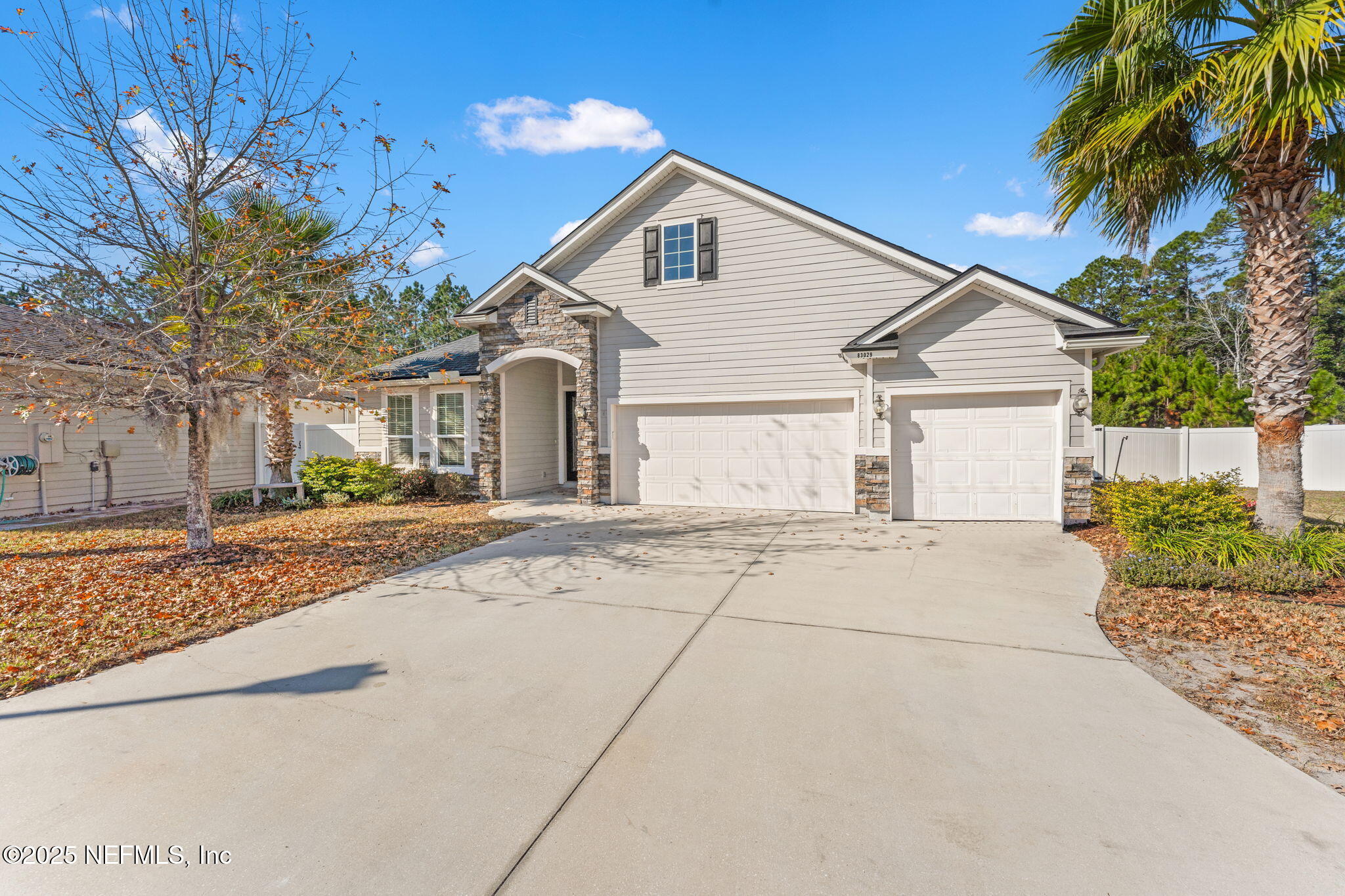 83029 Dowitcher Place Yulee, FL 32097 - Photo 3 of 40 a front view of a house with a yard and garage