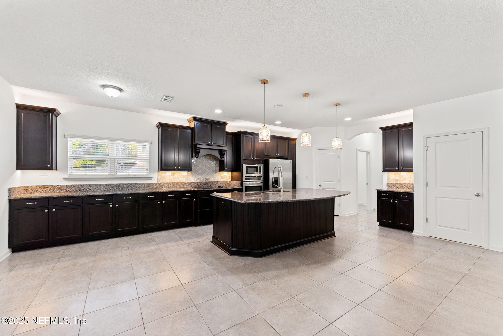 83029 Dowitcher Place Yulee, FL 32097 - Photo 8 of 40 a large kitchen with a large counter top and appliances