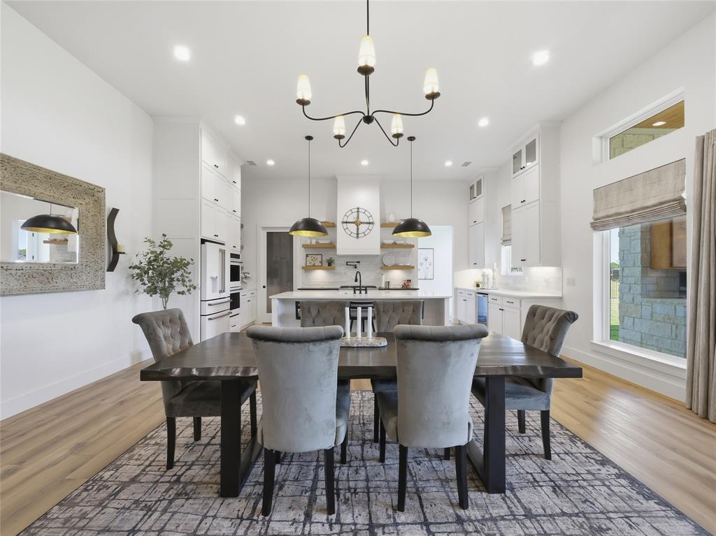 4211 Azalea Way Midlothian, TX 76065 - Photo 12 of 39 Open-concept living space featuring wood-finish flooring, a contemporary chandelier, and recessed lighting