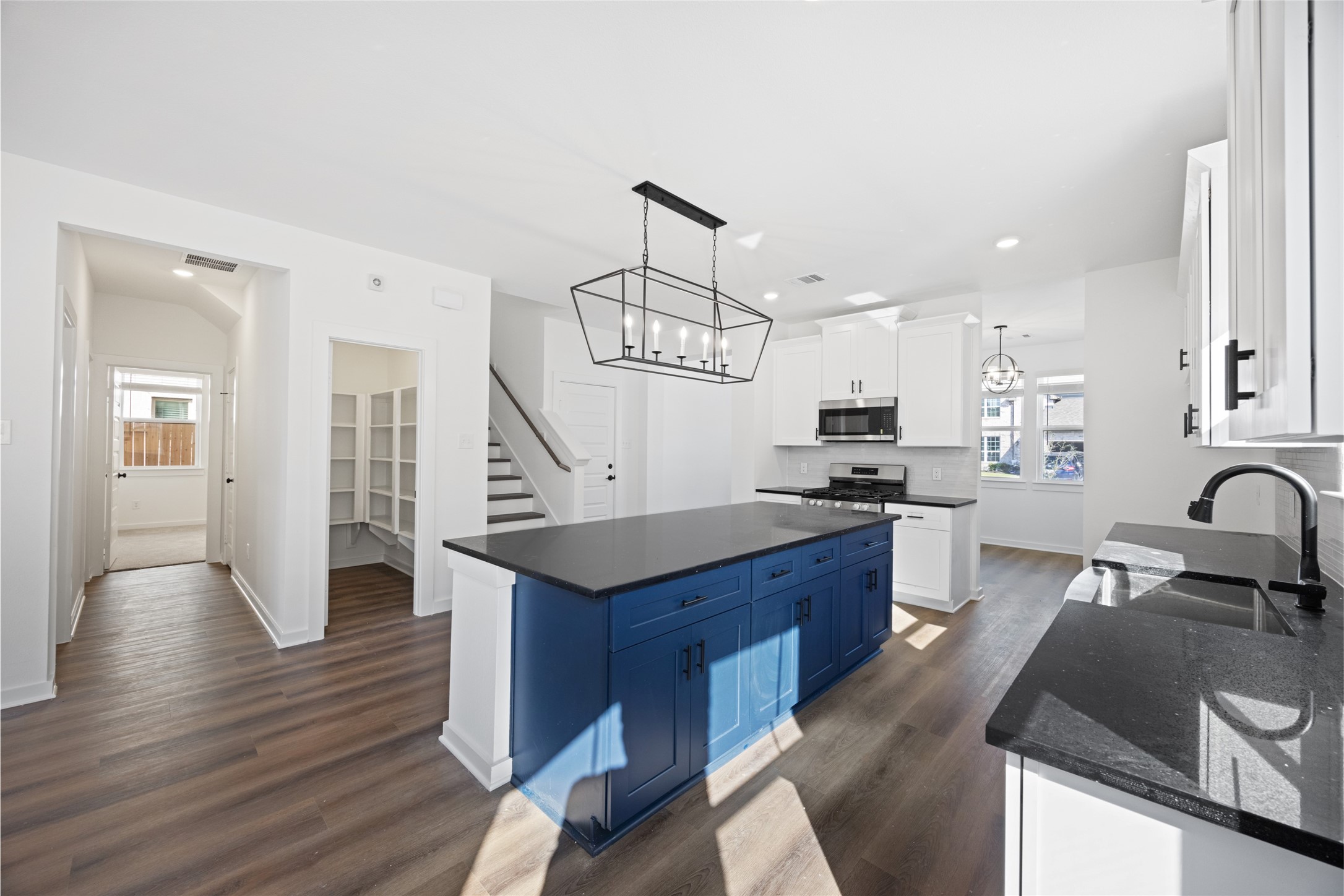 8326 Amethyst Valley Lane Angleton, TX 77515 - Photo 11 of 38 a kitchen with stainless steel appliances granite countertop a sink dishwasher stove and wooden floor