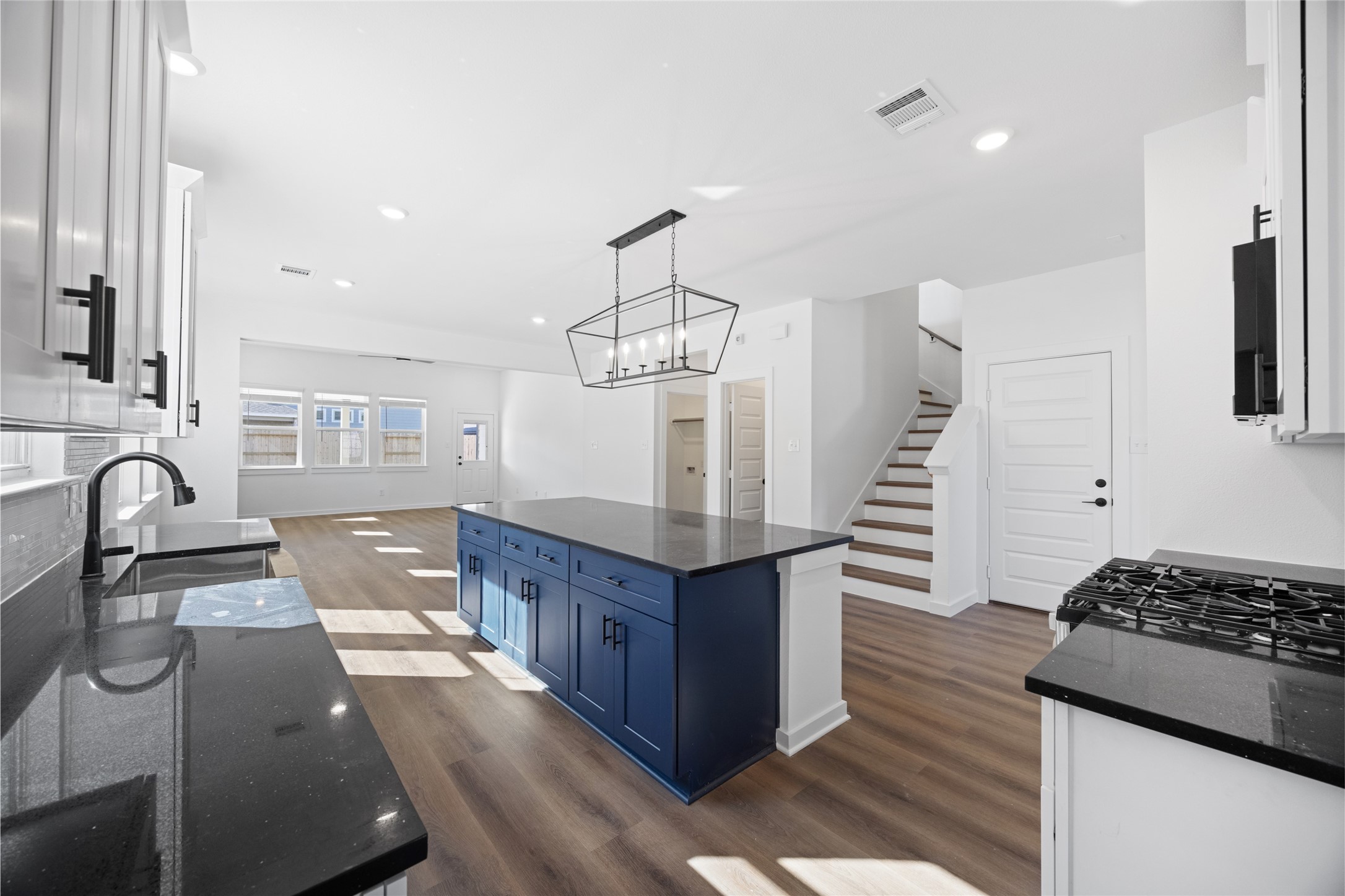8326 Amethyst Valley Lane Angleton, TX 77515 - Photo 7 of 38 a kitchen with stainless steel appliances granite countertop a stove and a refrigerator