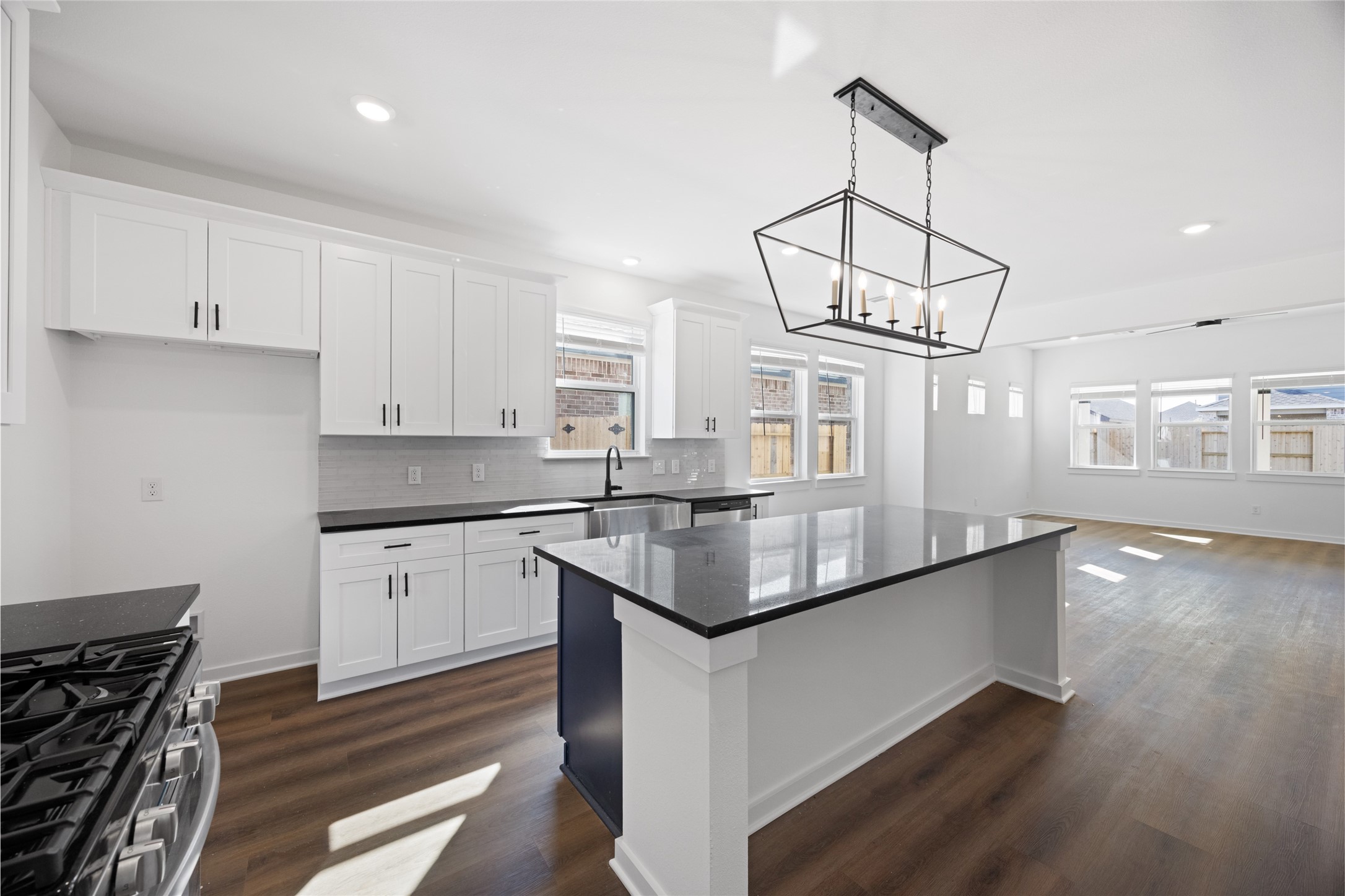 8326 Amethyst Valley Lane Angleton, TX 77515 - Photo 8 of 38 a kitchen with stainless steel appliances granite countertop a sink a stove and a wooden floors