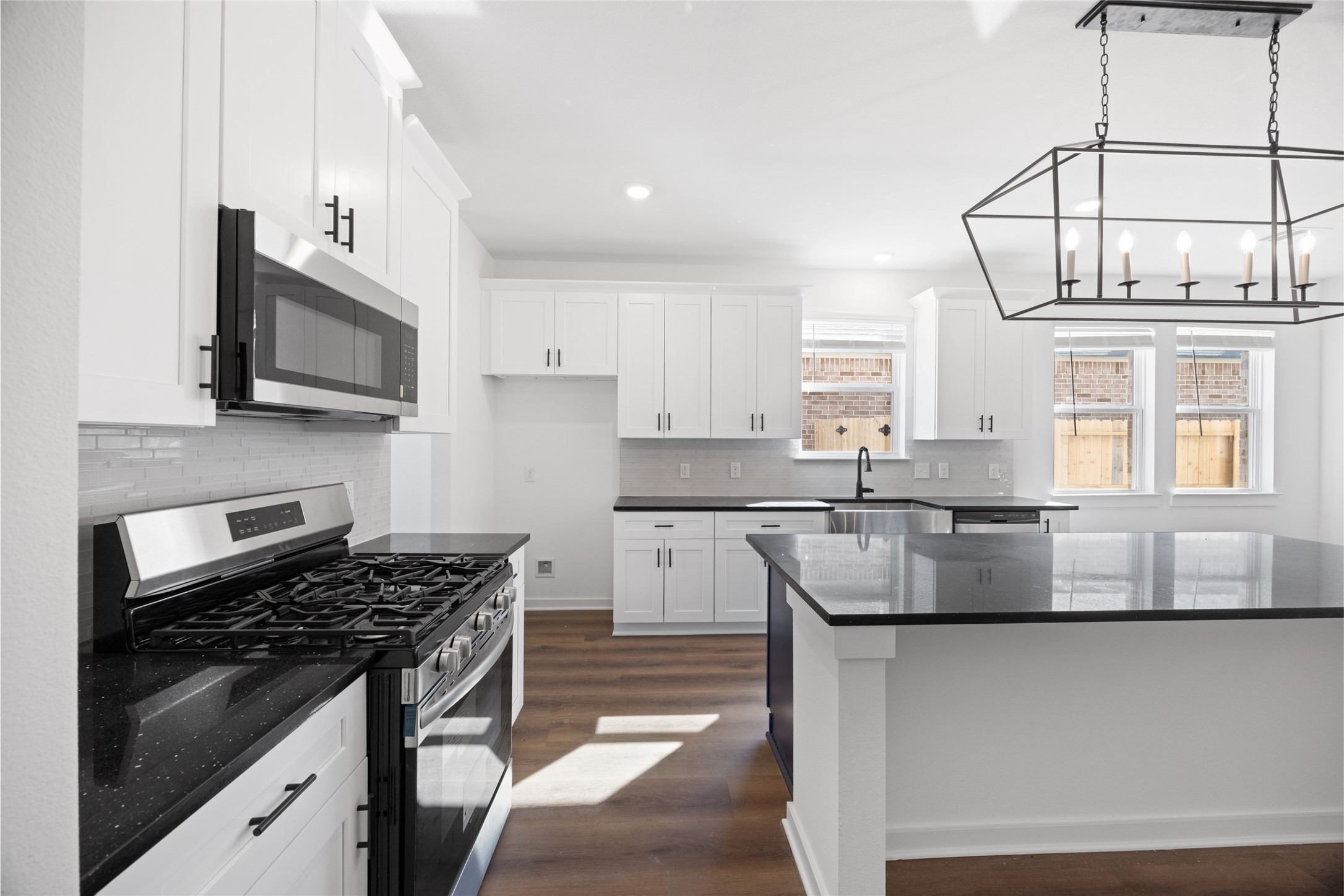 8326 Amethyst Valley Lane Angleton, TX 77515 - Photo 9 of 38 a kitchen with stainless steel appliances granite countertop a stove and a sink