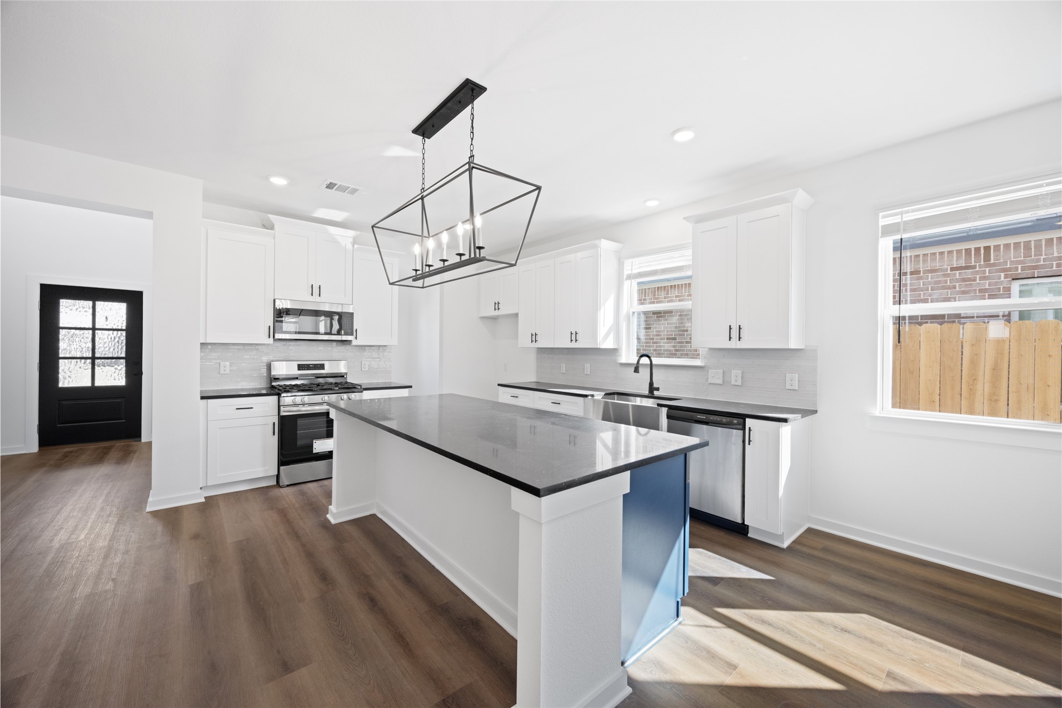 8326 Amethyst Valley Lane Angleton, TX 77515 - Photo 10 of 38 a kitchen with stainless steel appliances granite countertop a sink stove and refrigerator