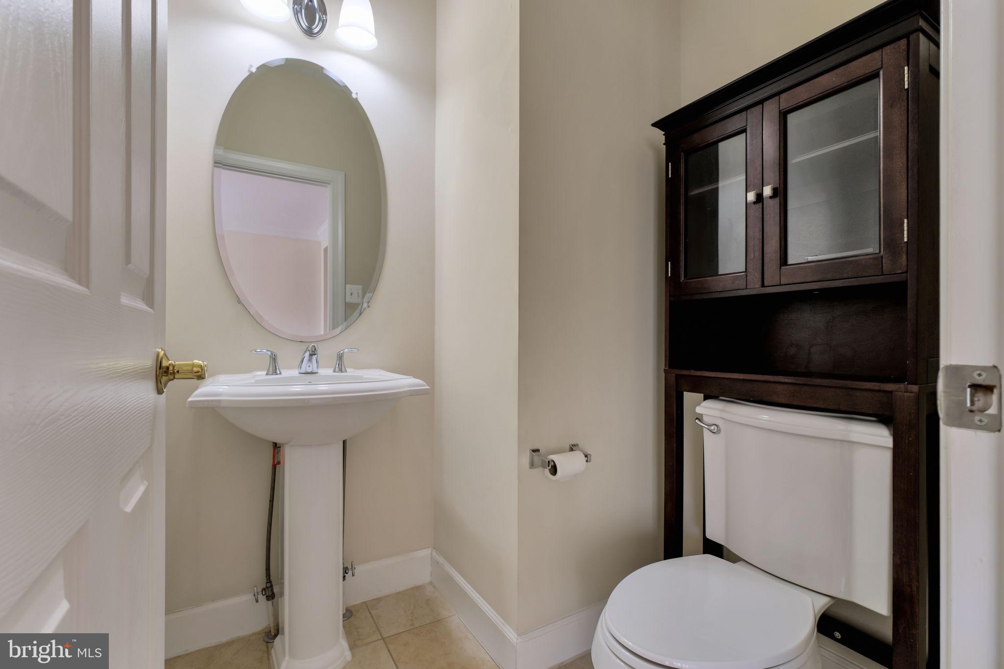 725 Ridgemont Avenue Rockville, MD 20850 - Photo 11 of 30 a bathroom with a toilet sink and mirror
