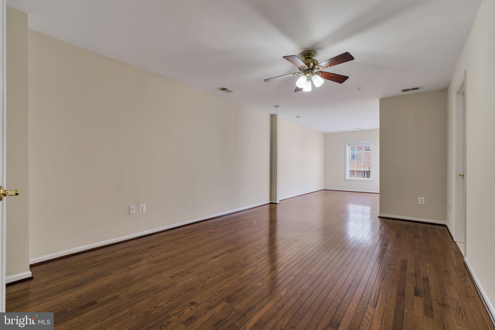 725 Ridgemont Avenue Rockville, MD 20850 - Photo 13 of 30 wooden floor in an empty room with a window