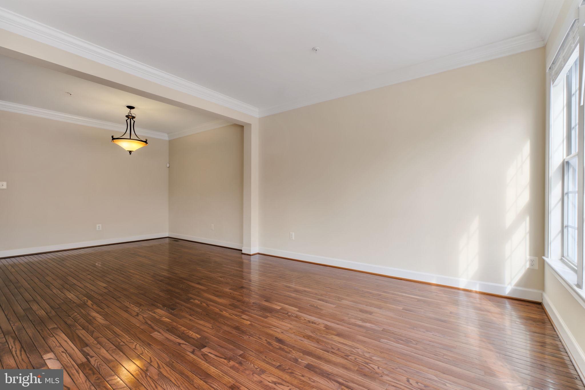 725 Ridgemont Avenue Rockville, MD 20850 - Photo 14 of 30 a view of empty room with wooden floor and fan