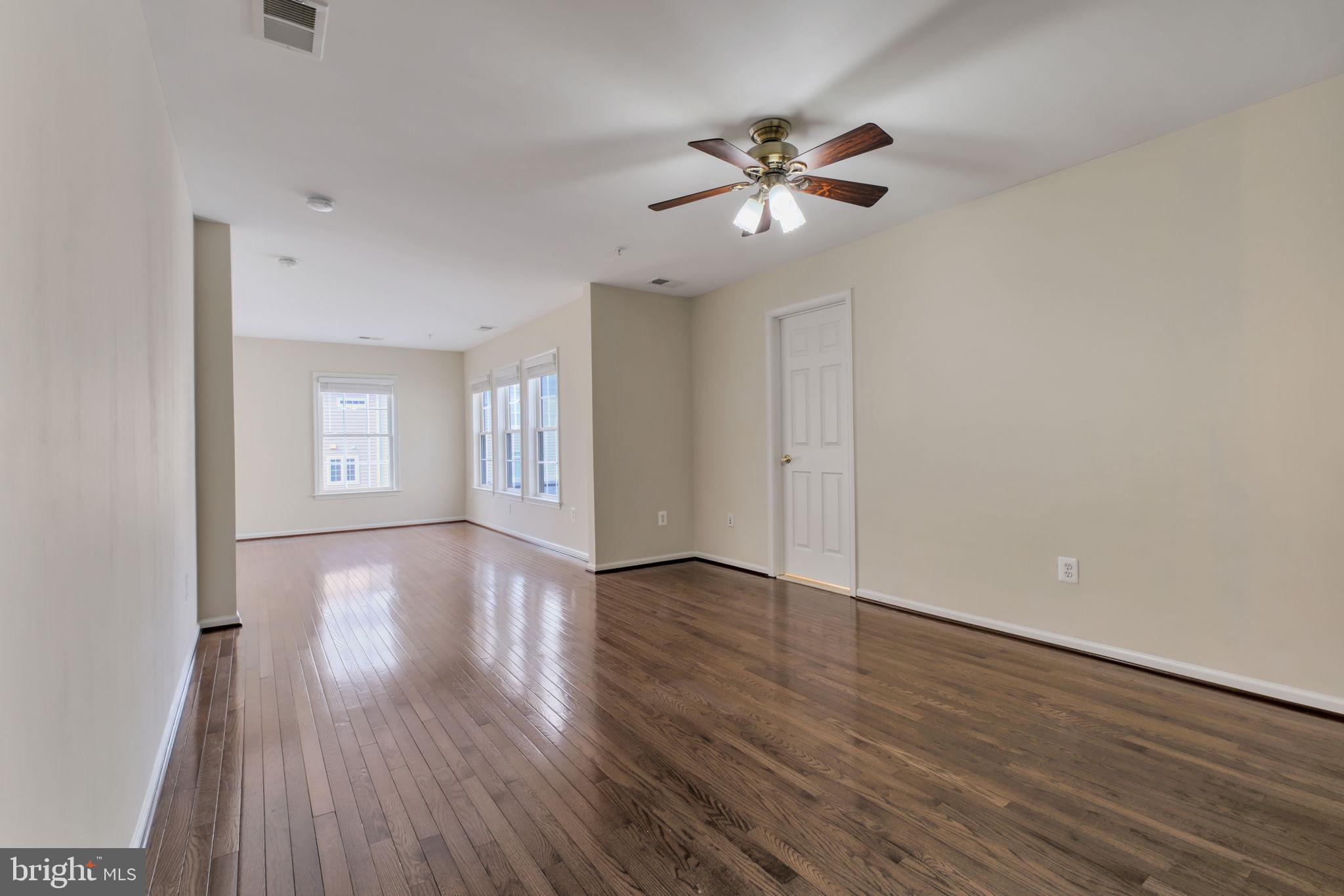 725 Ridgemont Avenue Rockville, MD 20850 - Photo 15 of 30 a view of an empty room with wooden floor and fan