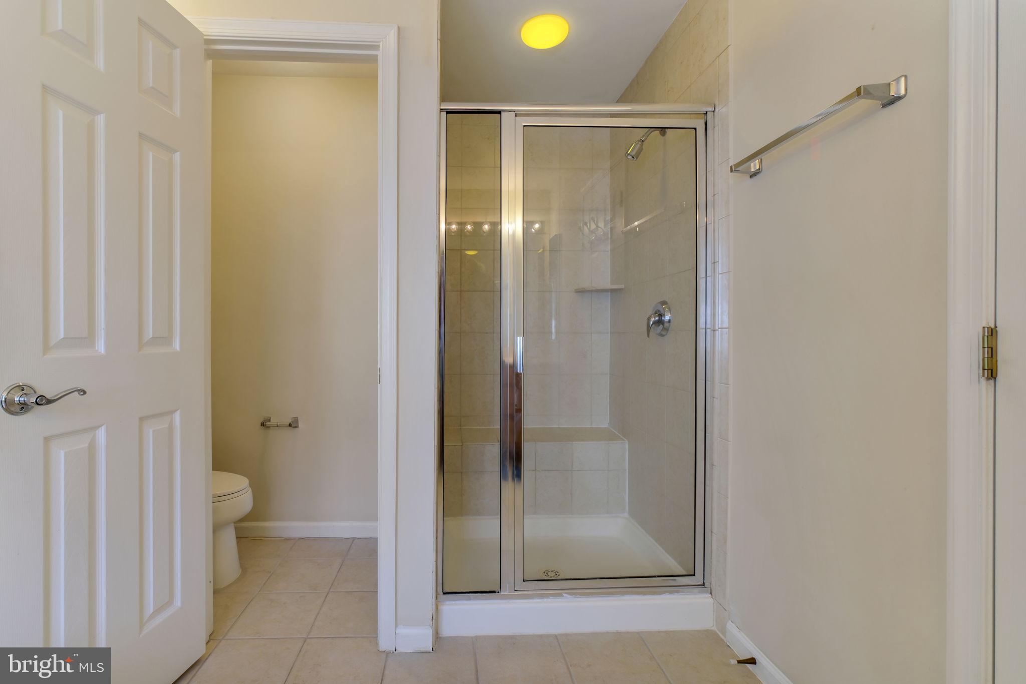 725 Ridgemont Avenue Rockville, MD 20850 - Photo 18 of 30 a bathroom with a glass shower door