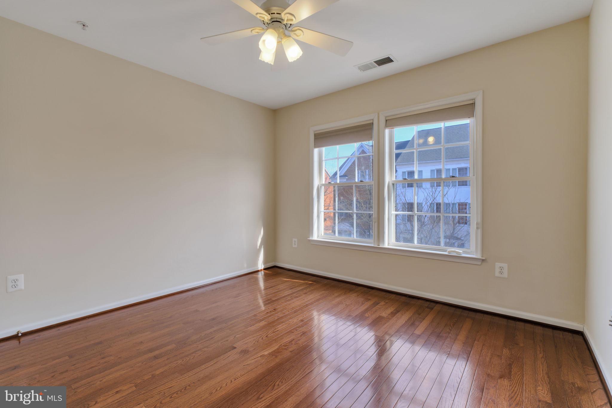 725 Ridgemont Avenue Rockville, MD 20850 - Photo 20 of 30 a view of an empty room with wooden floor and a window
