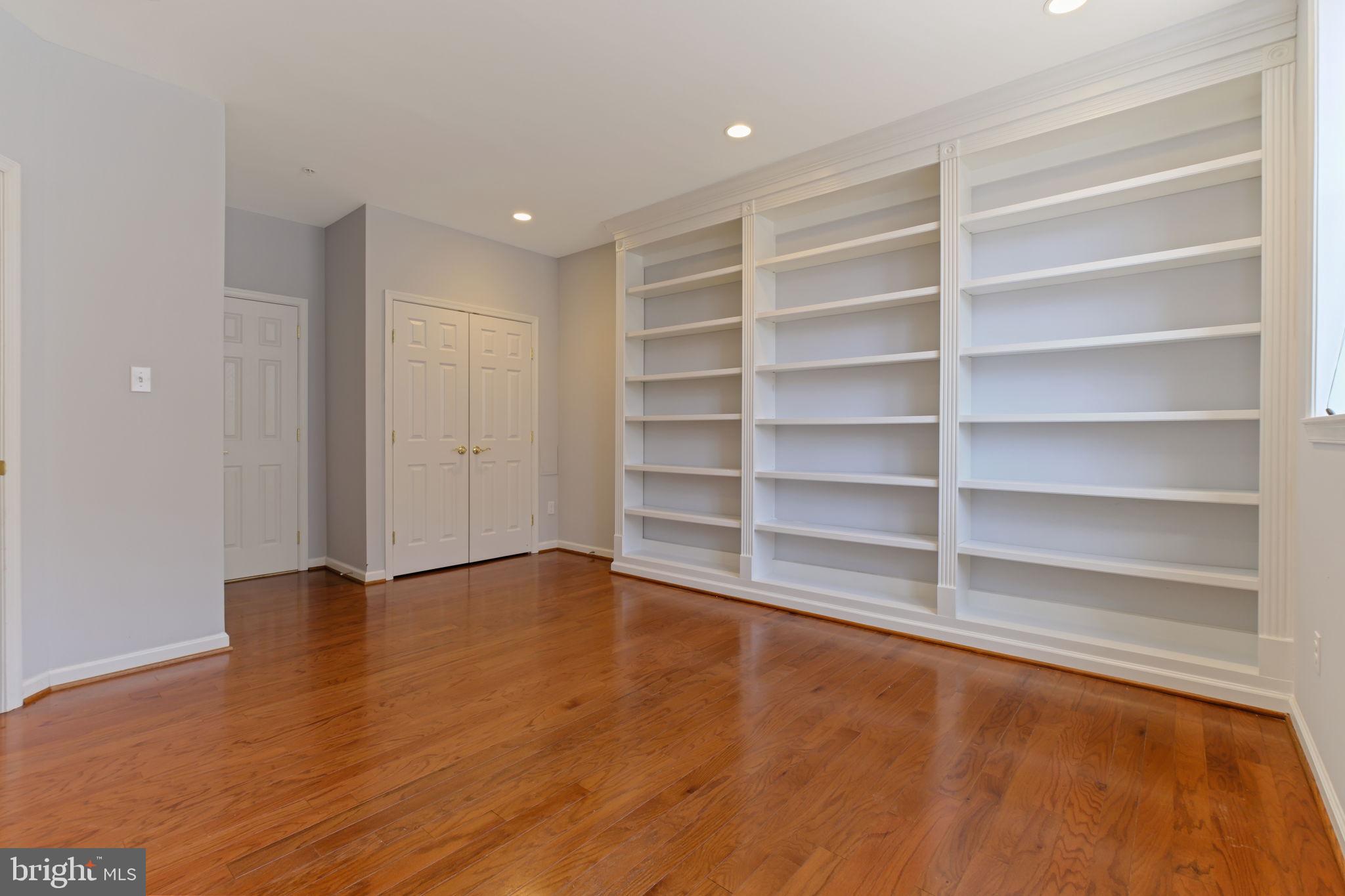 725 Ridgemont Avenue Rockville, MD 20850 - Photo 30 of 30 a view of an empty room with a wooden floor and a window