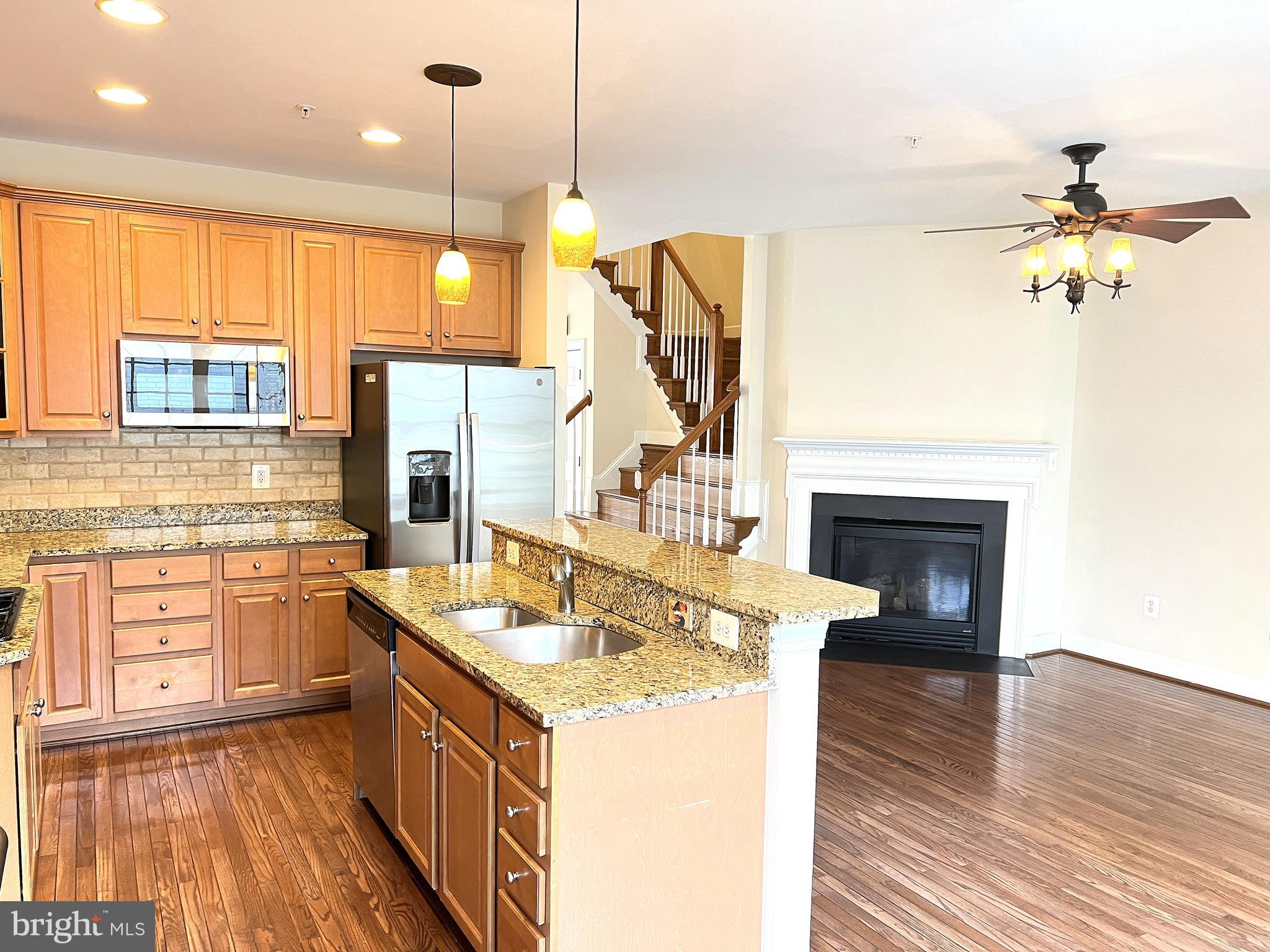 725 Ridgemont Avenue Rockville, MD 20850 - Photo 3 of 30 a kitchen with a sink stove and refrigerator