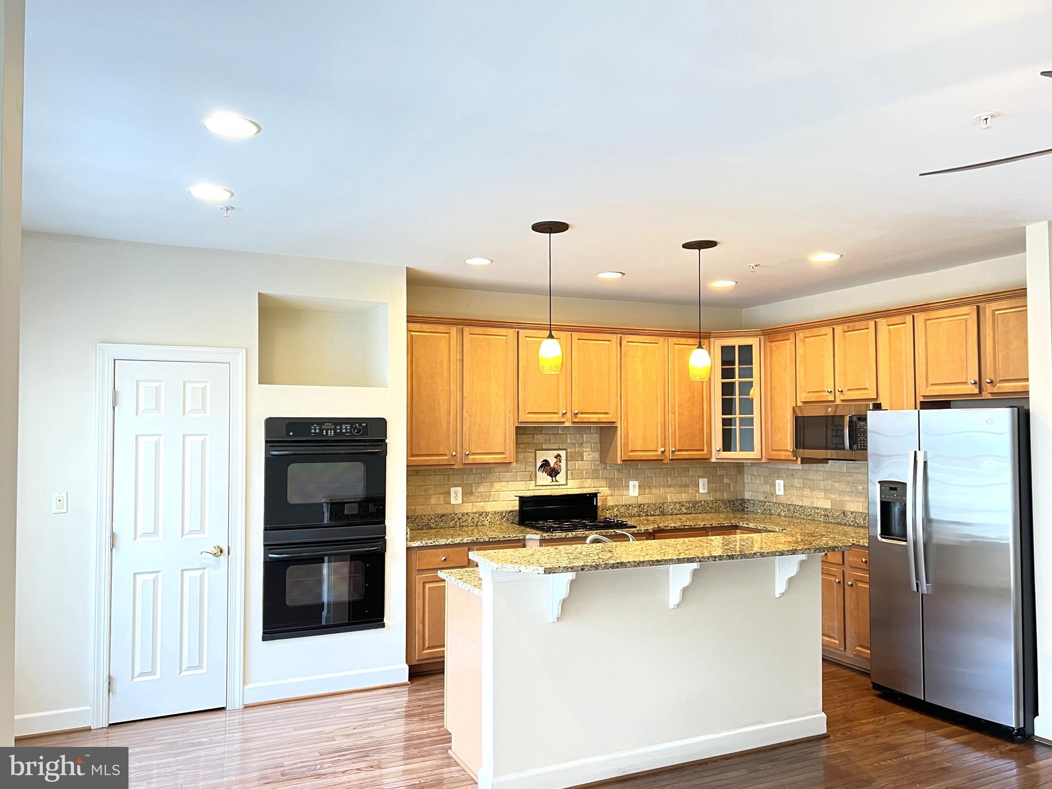 725 Ridgemont Avenue Rockville, MD 20850 - Photo 5 of 30 a kitchen with stainless steel appliances granite countertop a refrigerator a stove and a sink with cabinets