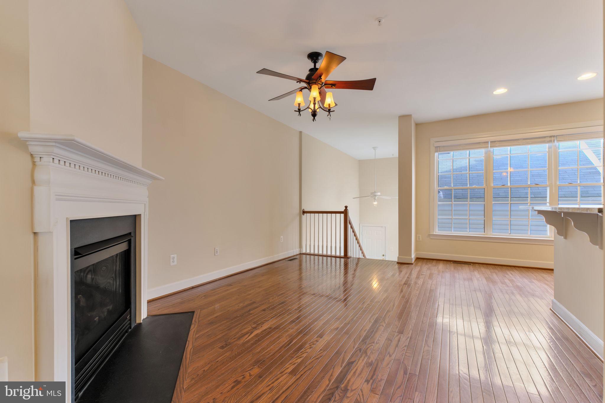 725 Ridgemont Avenue Rockville, MD 20850 - Photo 7 of 30 a view of empty room with wooden floor and fireplace