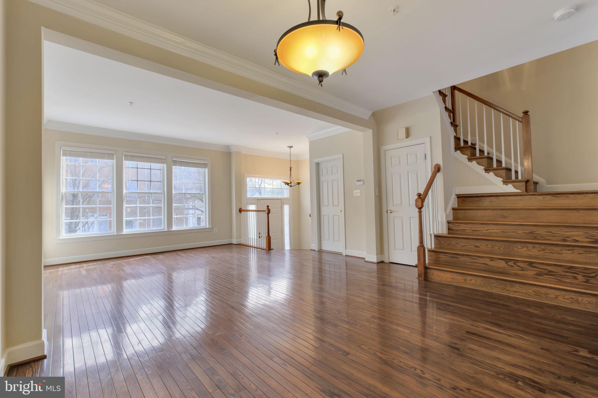 725 Ridgemont Avenue Rockville, MD 20850 - Photo 8 of 30 a view of an empty room with wooden floor and a window