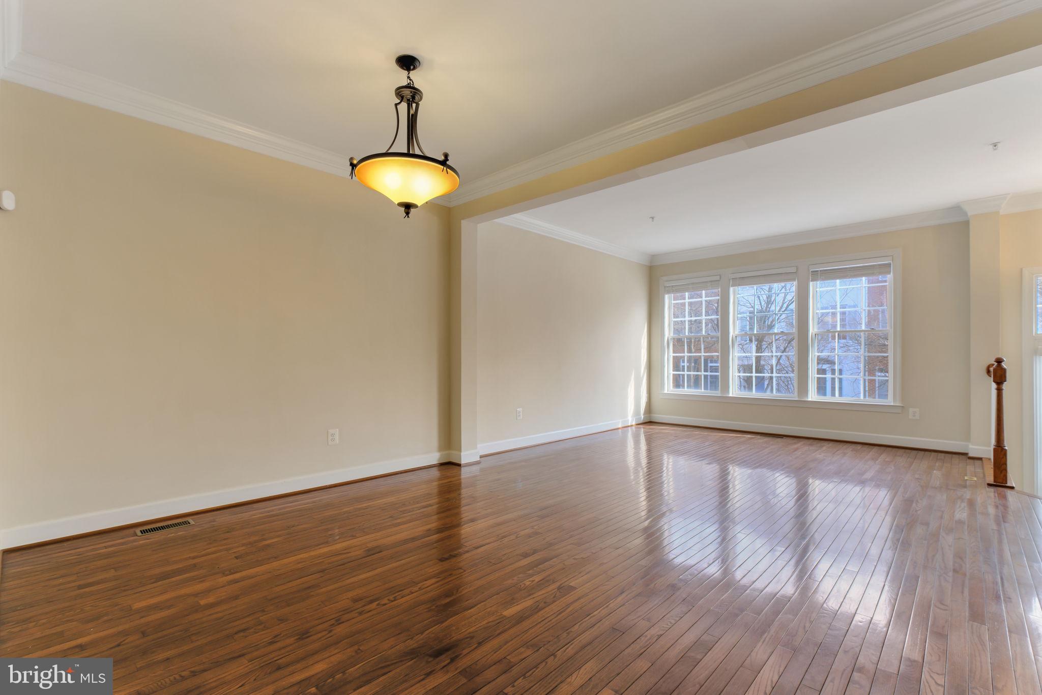 725 Ridgemont Avenue Rockville, MD 20850 - Photo 10 of 30 a view of an empty room with wooden floor and a window