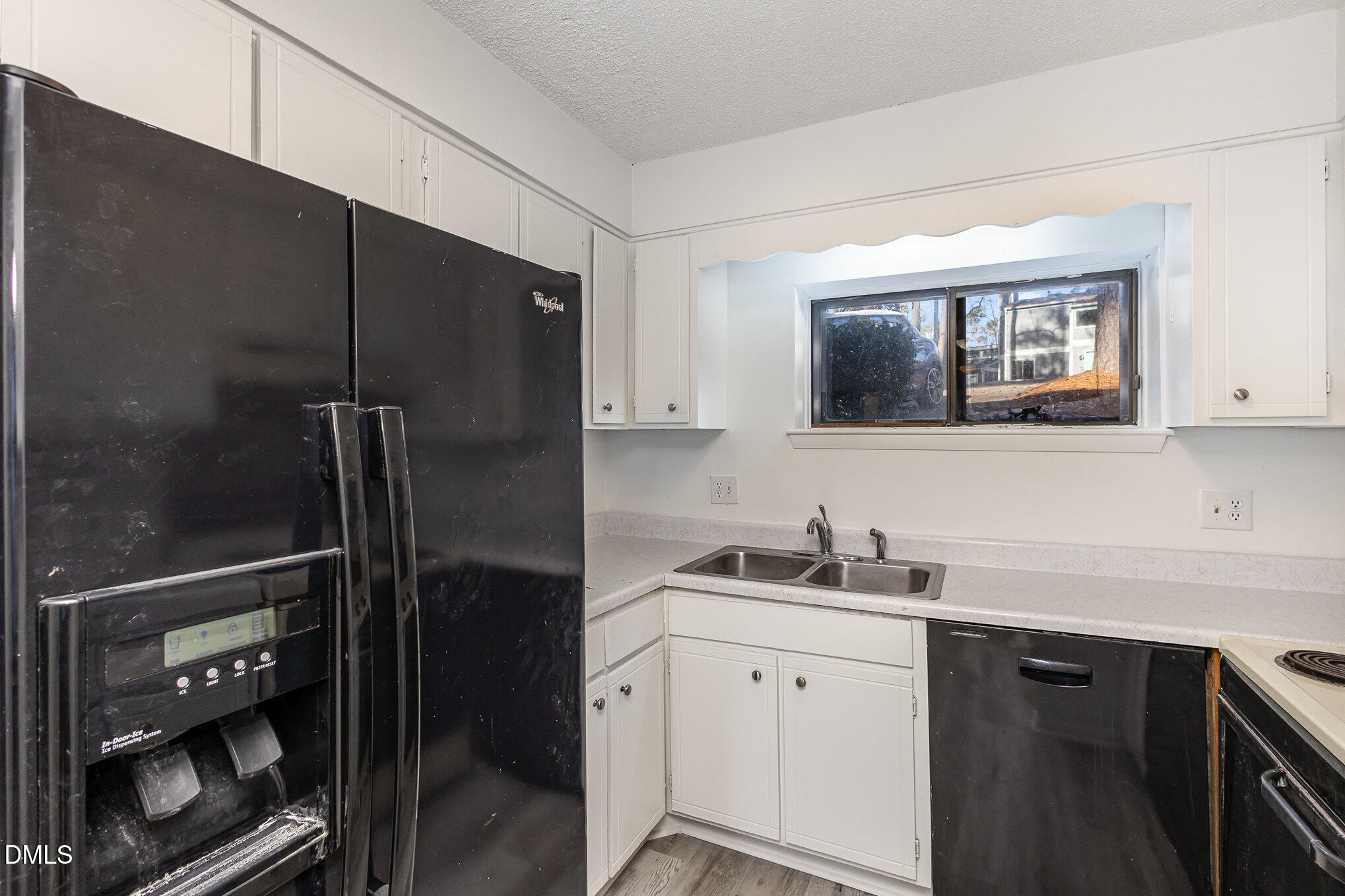 701 Godwin Court Raleigh, NC 27606 - Photo 11 of 29 a kitchen with a refrigerator and cabinets