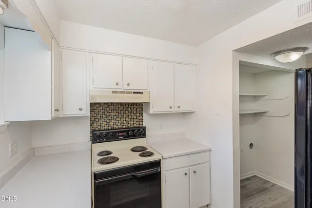 a kitchen with a stove and a cabinets