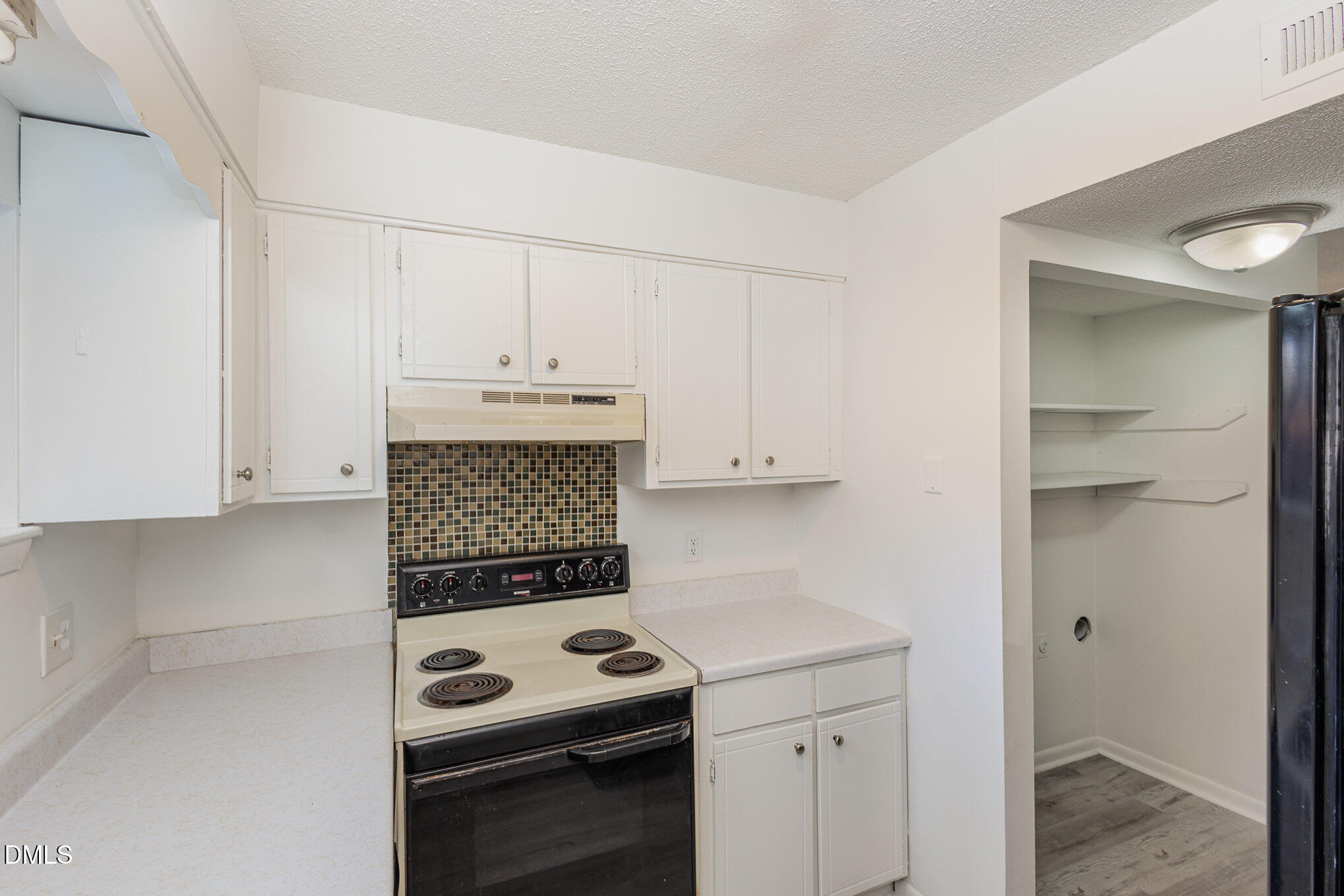 701 Godwin Court Raleigh, NC 27606 - Photo 12 of 29 a kitchen with a stove and a cabinets