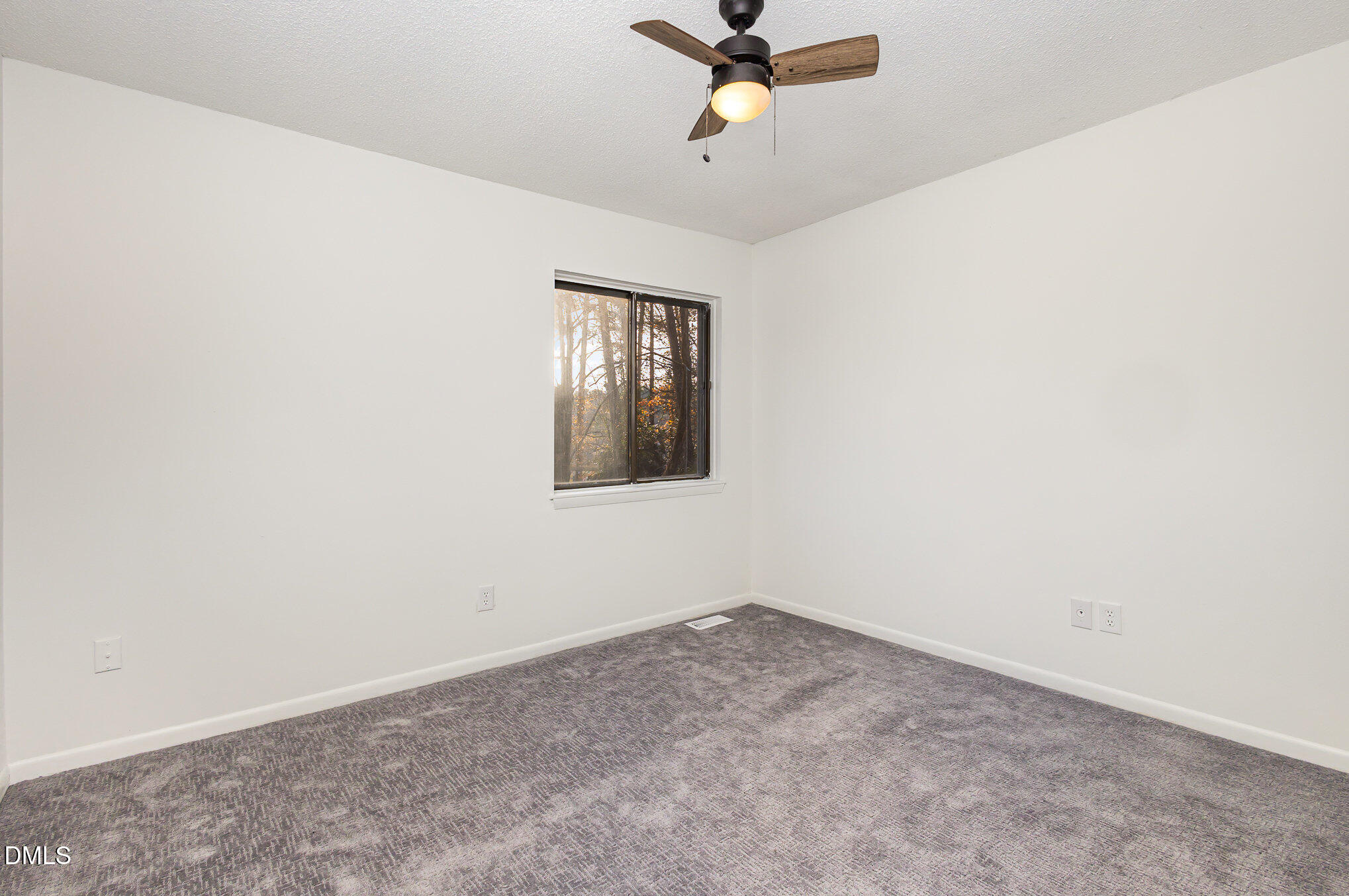 701 Godwin Court Raleigh, NC 27606 - Photo 22 of 29 an empty room with a window and a fan