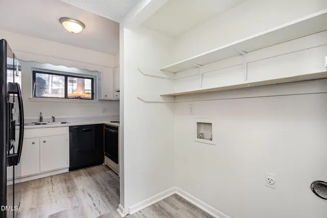 a view of a kitchen cabinets a sink and a window