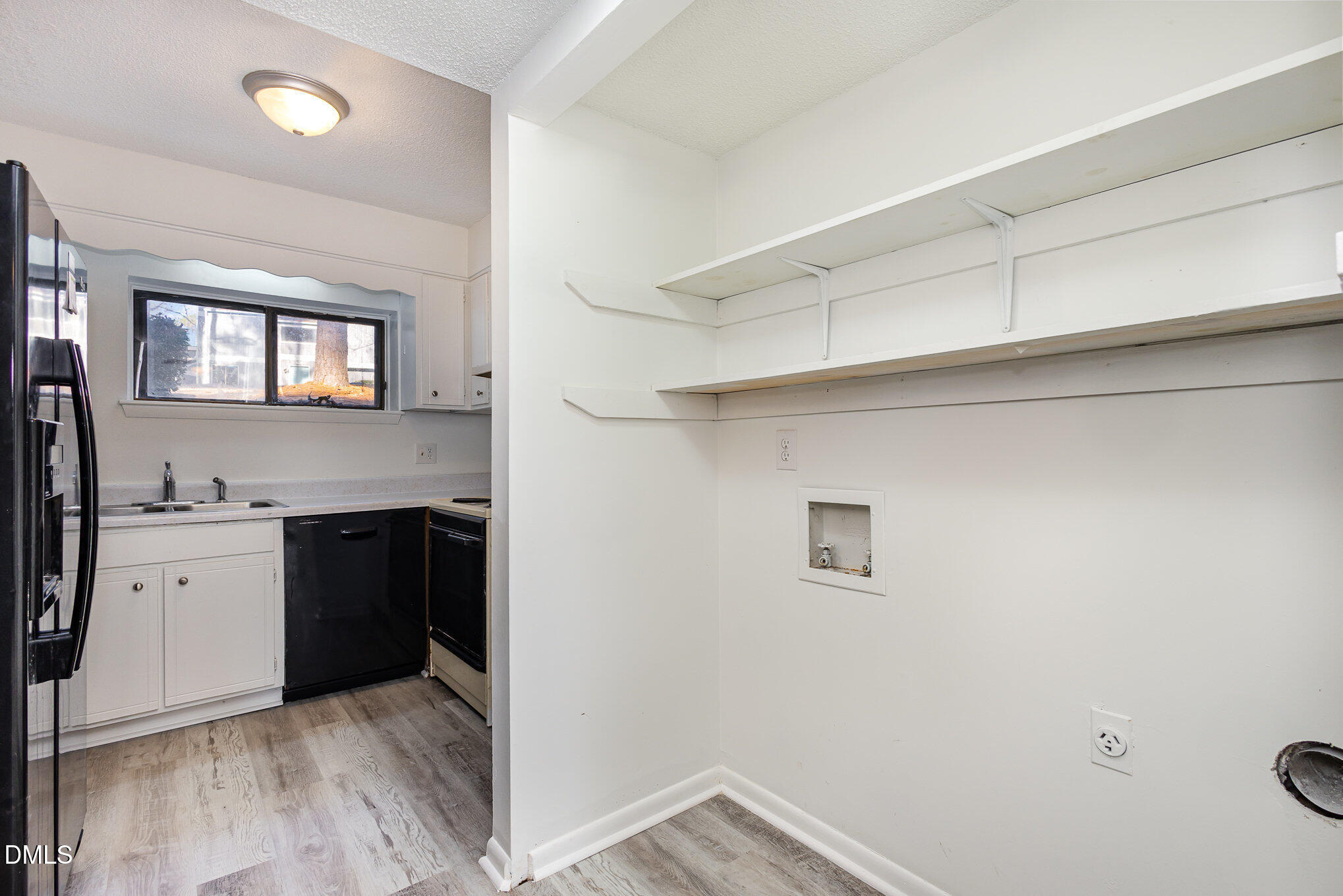 701 Godwin Court Raleigh, NC 27606 - Photo 24 of 29 a view of a kitchen cabinets a sink and a window