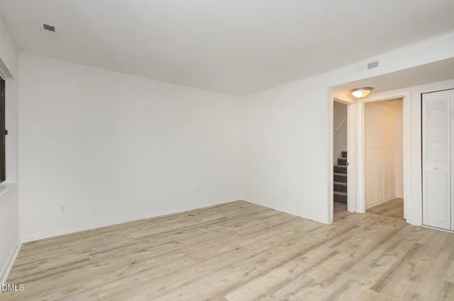 a view of a room with wooden floor