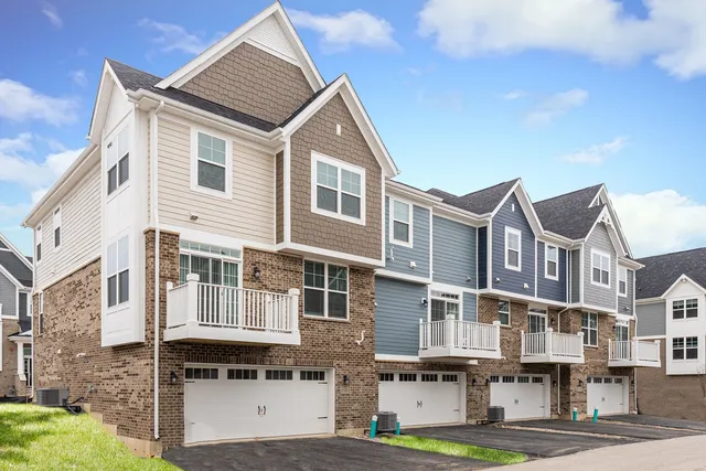 a front view of residential houses with yard