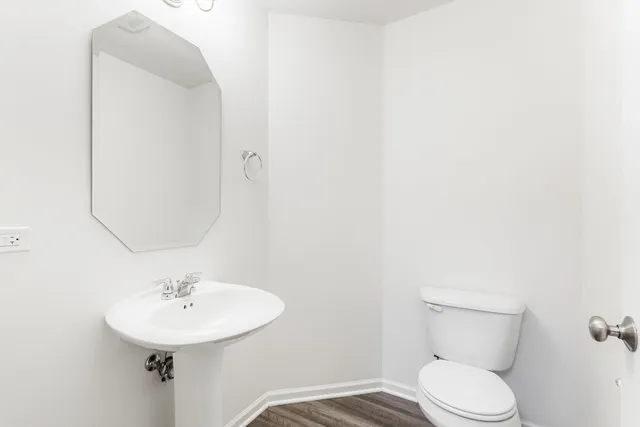 a bathroom with a sink a mirror and a toilet