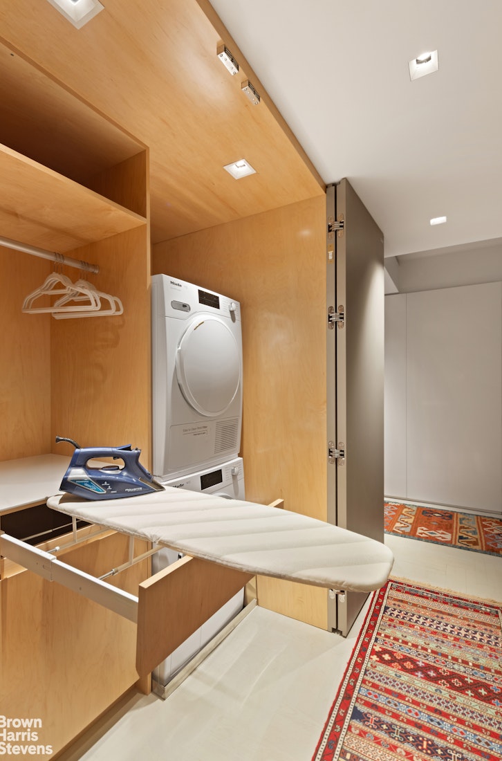 880 5th Avenue, Unit 7C Manhattan, NY 10021 - Photo 10 of 13 a room with a table and a mirror