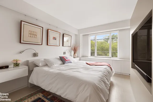 a living room with stainless steel appliances kitchen island granite countertop a refrigerator a stove and a sink with wooden floor