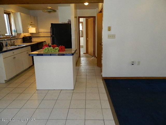 152 Chestnut Drive Bushkill, PA 18324 - Photo 14 of 34 a kitchen with stainless steel appliances a sink and a refrigerator