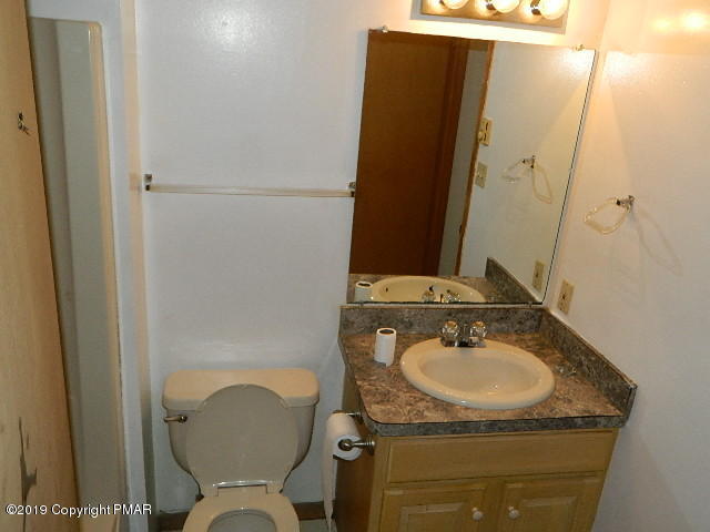 152 Chestnut Drive Bushkill, PA 18324 - Photo 15 of 34 a bathroom with a sink toilet and mirror