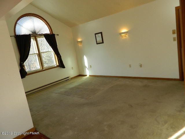 152 Chestnut Drive Bushkill, PA 18324 - Photo 17 of 34 an empty room with mirror on vanity and a window